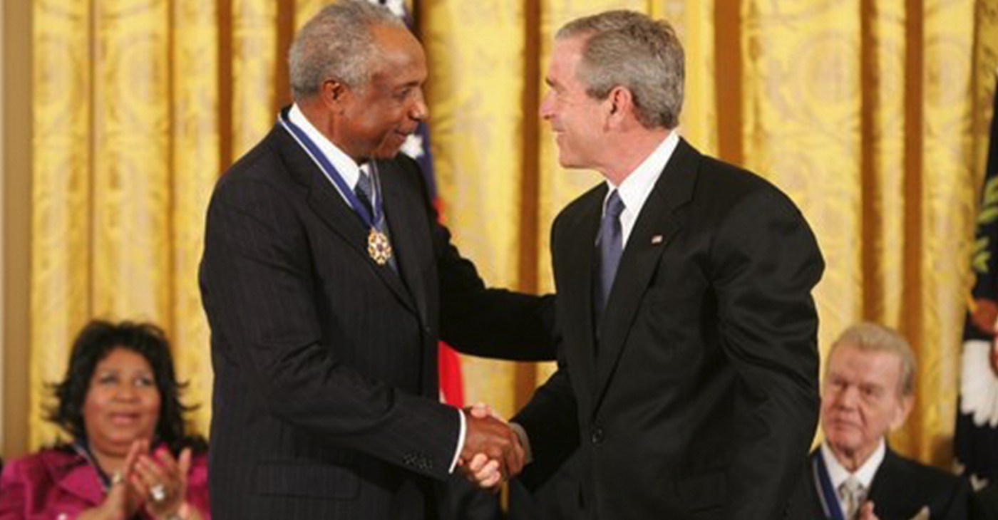 President George W. Bush presents the Presidential Medal of Freedom to baseball legend Frank Robinson in the East Room Wednesday, Nov. 9, 2005. Winning the Most Valuable Player awards in the National and American Leagues, he achieved the American League Triple Crown in 1966. Mr. Robinson became baseball's first African-American manager. (Source: White House News & Policies / Wikimedia Commons)  The citation reads: “Frank Robinson played the game of baseball with total integrity and steadfast determination. He won Most Valuable Player awards in both the National and American Leagues. He achieved the American League Triple Crown in 1966. His teams won five League titles and two World Series championships. In 1975, Frank Robinson broke the color barrier as baseball's first African-American manager, and he later won Manager of the Year awards in both the National and American Leagues. The United States honors Frank Robinson for his extraordinary achievements as a baseball player and manager and for setting a lasting example of character in athletics.” 